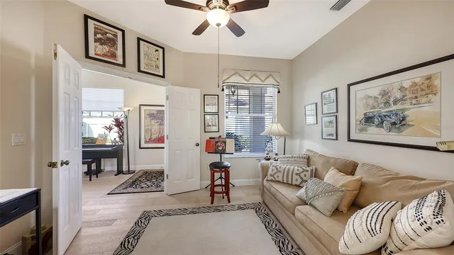 a living room with furniture and a chandelier