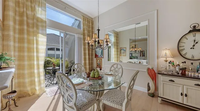 a view of a dining room with furniture and chandelier