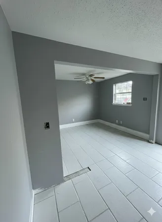 a view of an empty room with windows