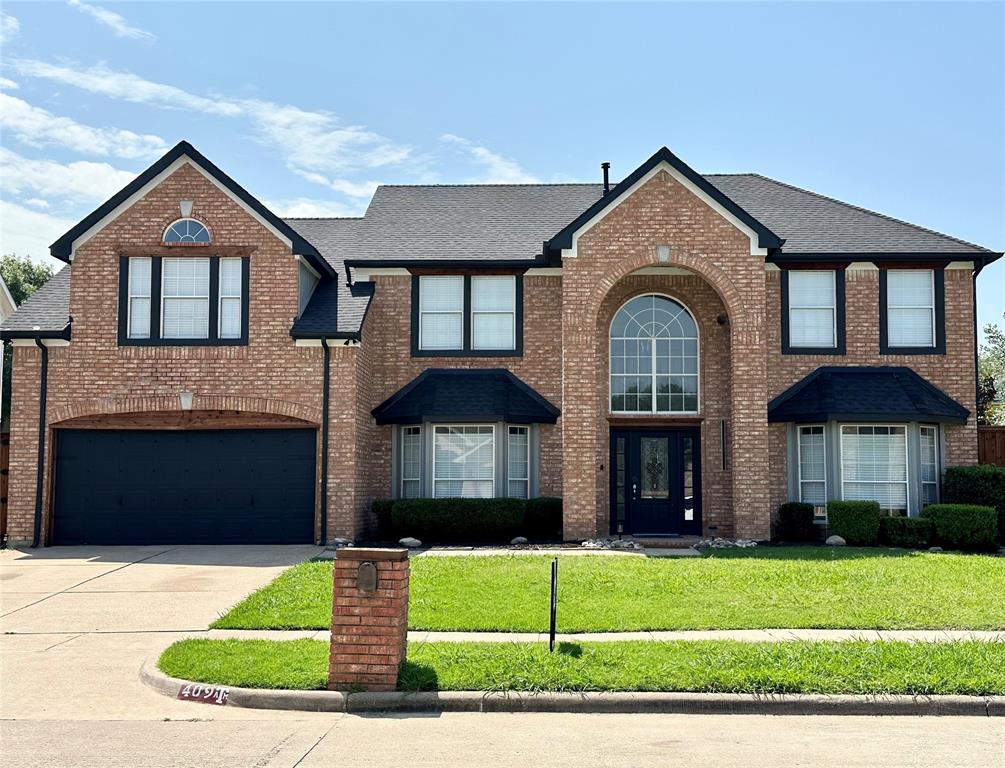 409 Baldwin Street Grand Prairie, TX 75052 - Photo 1 of 1 a front view of a house with a yard and garage