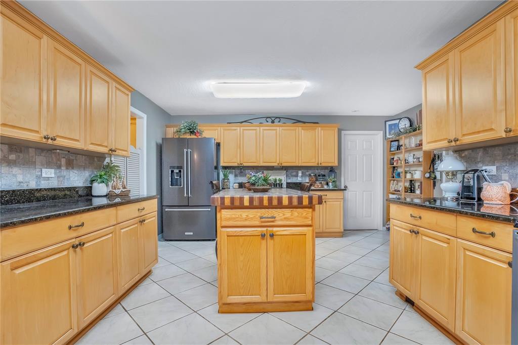 2067 Lake Juanita Road Seville, FL 32190 - Photo 13 of 96 a kitchen with stainless steel appliances granite countertop a refrigerator a stove top oven and white cabinets