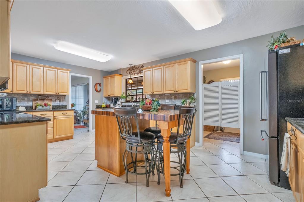 2067 Lake Juanita Road Seville, FL 32190 - Photo 17 of 96 a kitchen with stainless steel appliances granite countertop a stove a sink a microwave and a refrigerator
