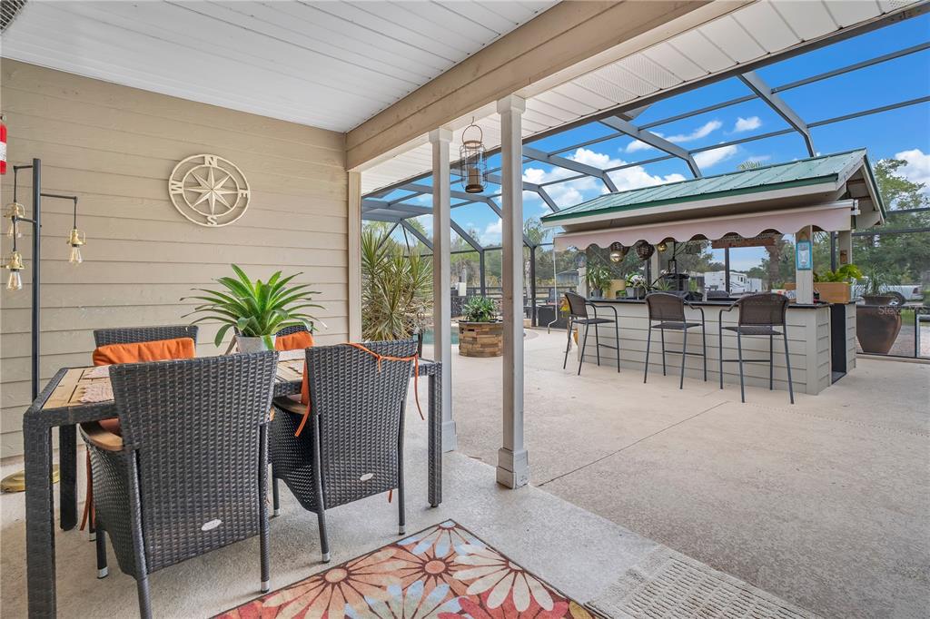 2067 Lake Juanita Road Seville, FL 32190 - Photo 29 of 96 a dining room with furniture and a potted plant