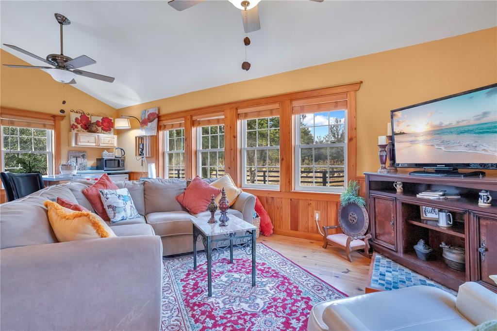 2067 Lake Juanita Road Seville, FL 32190 - Photo 49 of 96 a living room with furniture a rug and a floor to ceiling window