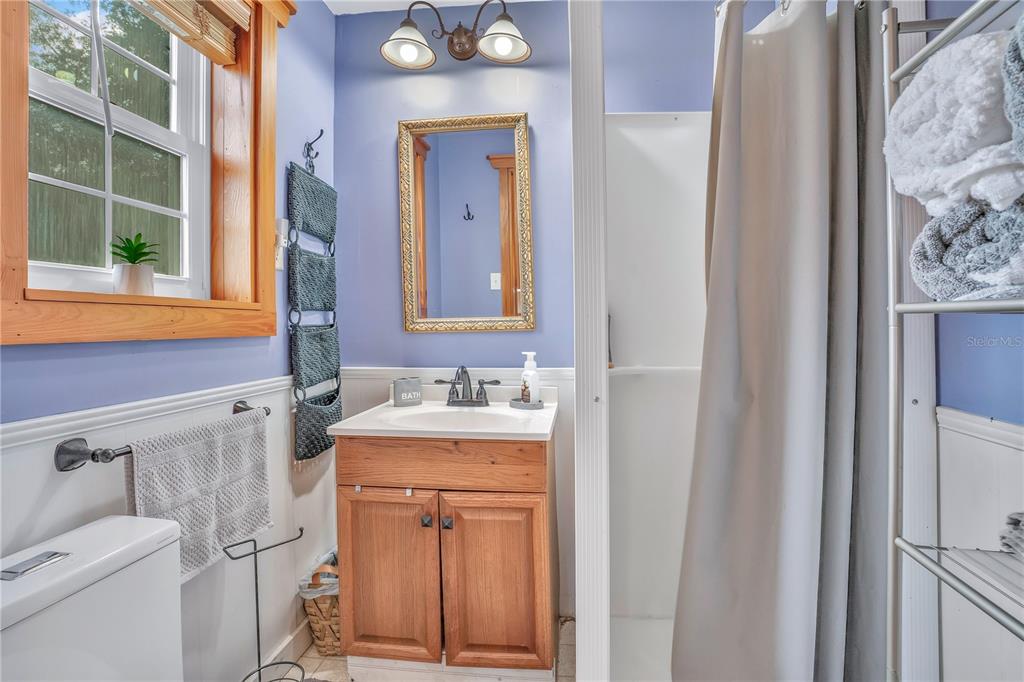 2067 Lake Juanita Road Seville, FL 32190 - Photo 55 of 96 a bathroom with a granite countertop sink toilet and mirror