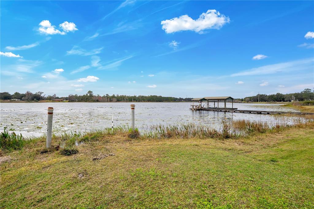 2067 Lake Juanita Road Seville, FL 32190 - Photo 75 of 96 a view of a lake with houses in the background