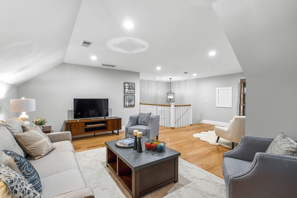 2 Pioneer Road, Unit 2 Framingham, MA 01701 - Photo 9 of 12 a living room with furniture and a flat screen tv