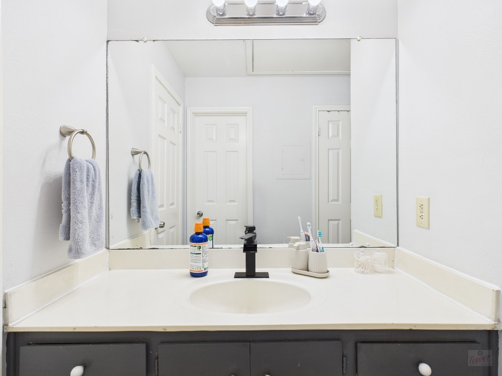 2529 Rio Grande Street, Unit 101 Austin, TX 78705 - Photo 17 of 18 a bathroom with a sink and a mirror