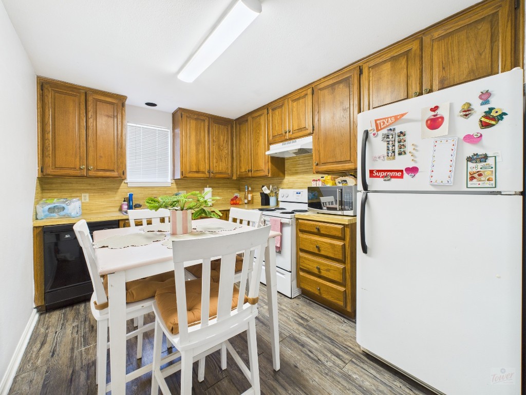 2529 Rio Grande Street, Unit 101 Austin, TX 78705 - Photo 5 of 18 a kitchen with a cabinets a sink and white appliances