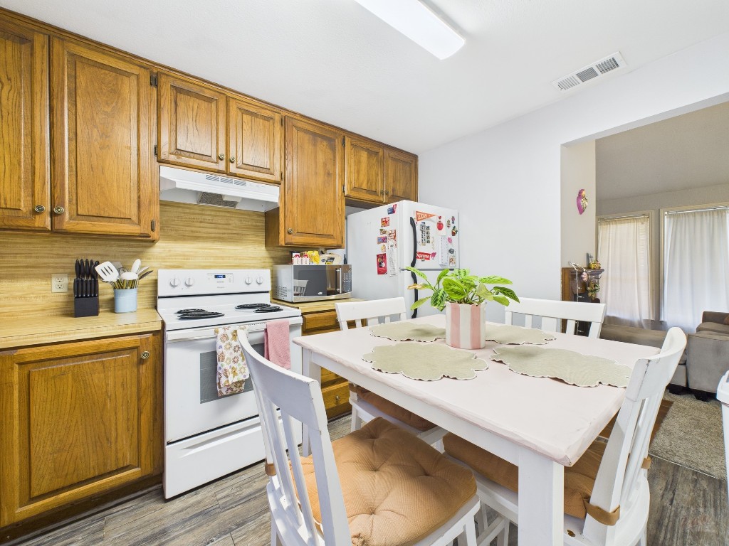 2529 Rio Grande Street, Unit 101 Austin, TX 78705 - Photo 7 of 18 a kitchen with a sink a stove and white cabinets