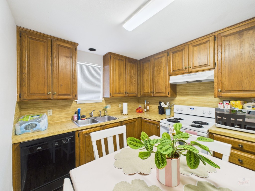 2529 Rio Grande Street, Unit 101 Austin, TX 78705 - Photo 8 of 18 a kitchen with a sink stove and wooden cabinets