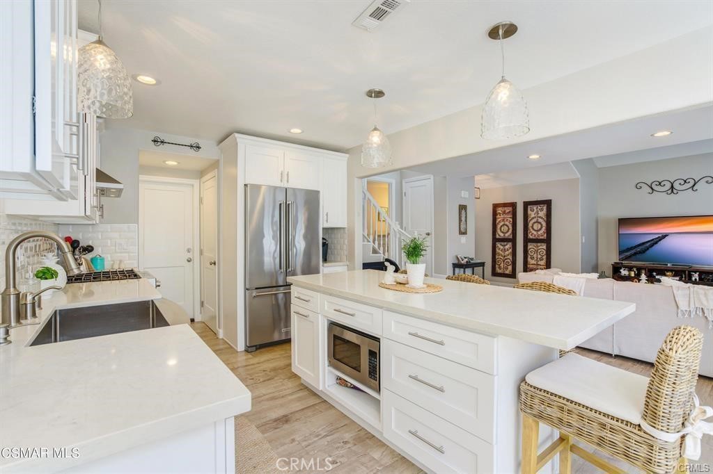 1948 Rory Lane, Unit 4 Simi Valley, CA 93063 - Photo 11 of 23 a large kitchen with stainless steel appliances a center island cabinets and a refrigerator