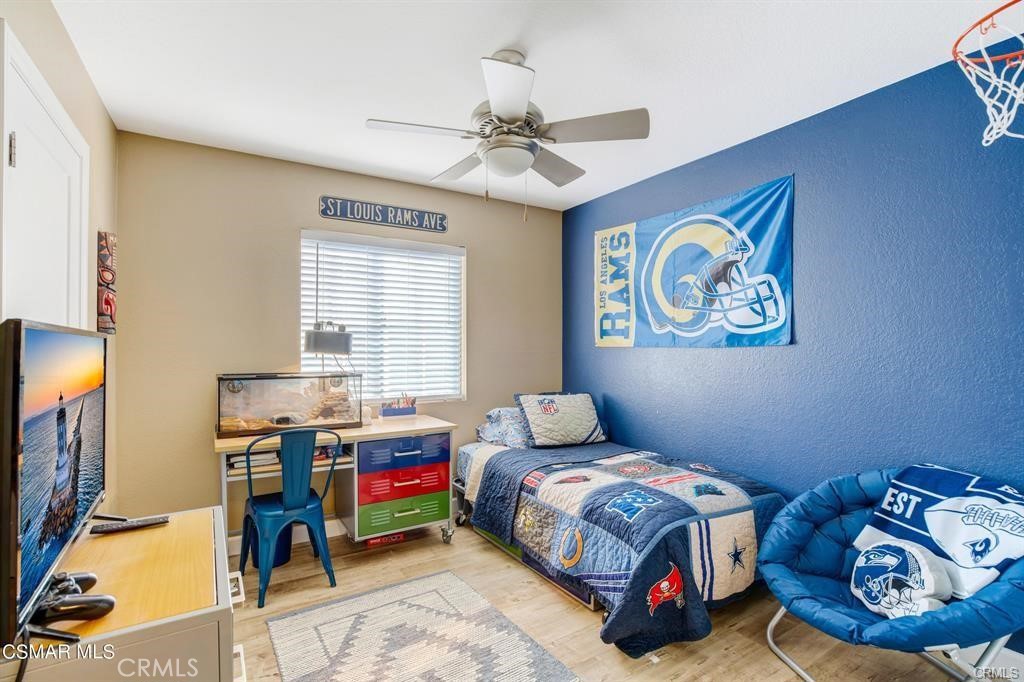 1948 Rory Lane, Unit 4 Simi Valley, CA 93063 - Photo 21 of 23 a bedroom with a bed and a flat screen tv