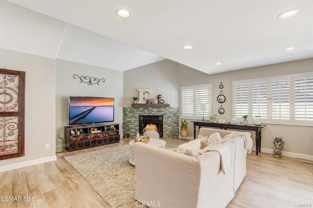 1948 Rory Lane, Unit 4 Simi Valley, CA 93063 - Photo 3 of 23 a living room with furniture a fireplace and a flat screen tv