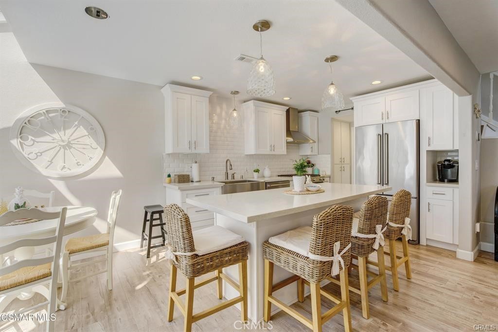 1948 Rory Lane, Unit 4 Simi Valley, CA 93063 - Photo 7 of 23 a kitchen with stainless steel appliances granite countertop a table chairs and a refrigerator