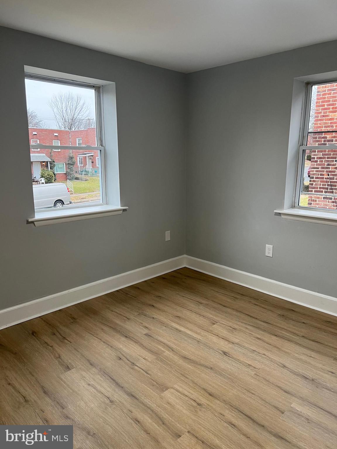 8511 Chestnut Oak Road Parkville, MD 21234 - Photo 11 of 17 a view of an empty room with wooden floor and a window