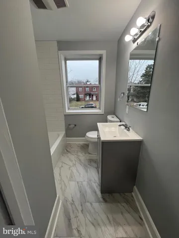 a bathroom with a sink toilet and mirror