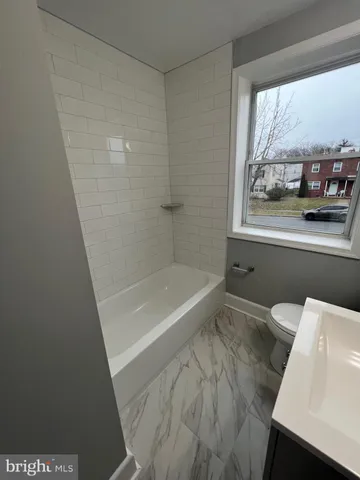 a bathroom with a bathtub and window