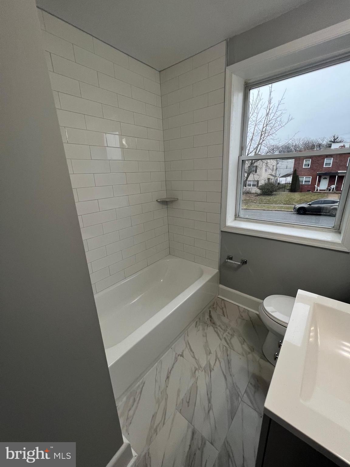 8511 Chestnut Oak Road Parkville, MD 21234 - Photo 16 of 17 a bathroom with a bathtub and window