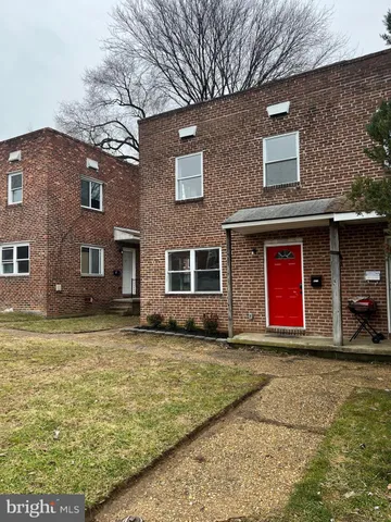 a house view with a swimming pool in front of it