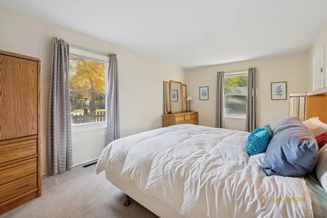 a bedroom with a large bed and a window