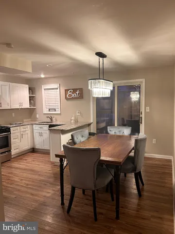a view of a dining room with furniture wooden floor and chandelier