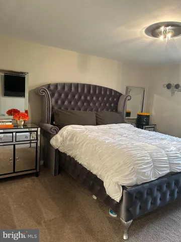 a bedroom with a bed and dresser