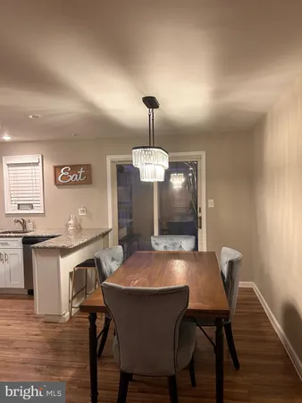 a view of a dining room with furniture wooden floor and a chandelier