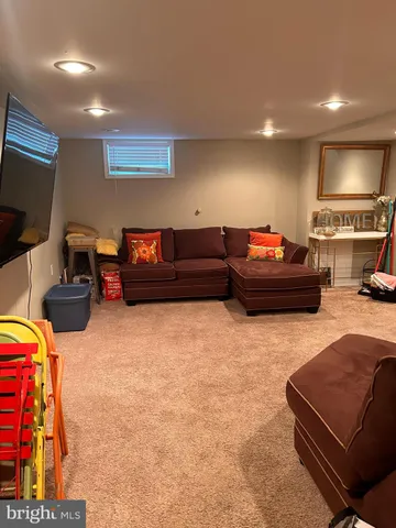 a backyard of a house with furniture and a rug