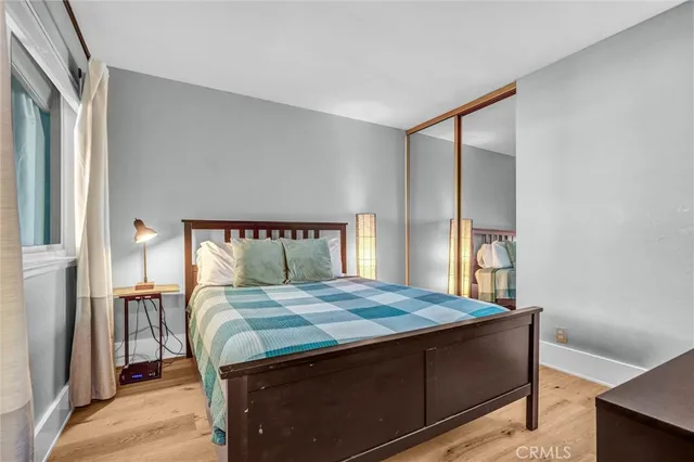 a bed sitting in a bedroom next to a window