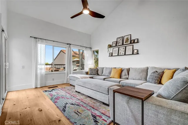 a living room with furniture and a floor to ceiling window