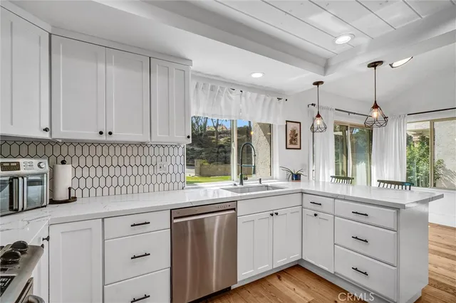 a kitchen with a sink window and cabinets
