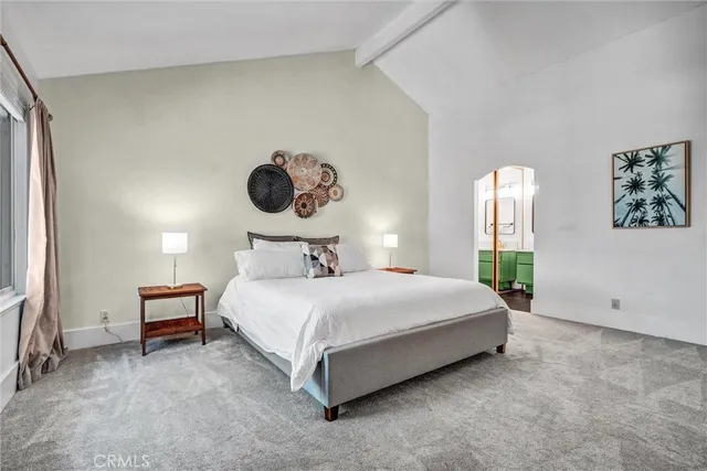 a bedroom with a bed and painting on the wall