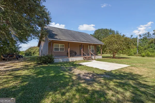 a view of a house with a yard and tree s
