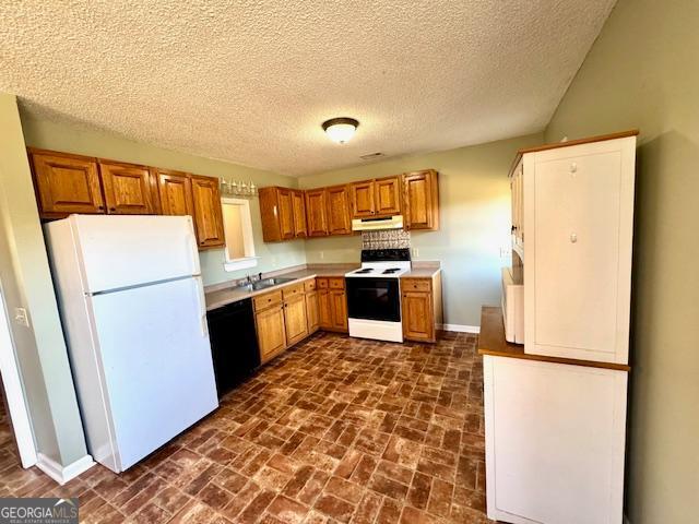 983 Johnny Brannen Road Statesboro, GA 30458 - Photo 14 of 27 a kitchen with a refrigerator a stove top oven and a counter top space