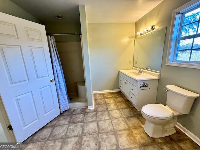 983 Johnny Brannen Road Statesboro, GA 30458 - Photo 20 of 27 a bathroom with a sink a toilet a mirror and shower