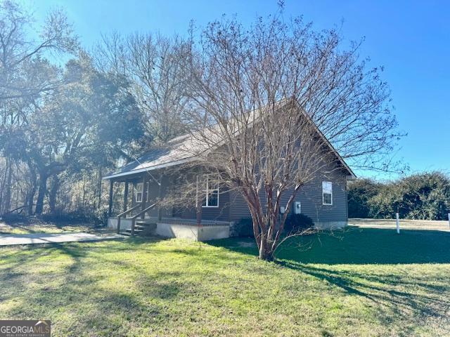 983 Johnny Brannen Road Statesboro, GA 30458 - Photo 24 of 27 a view of a house with a yard