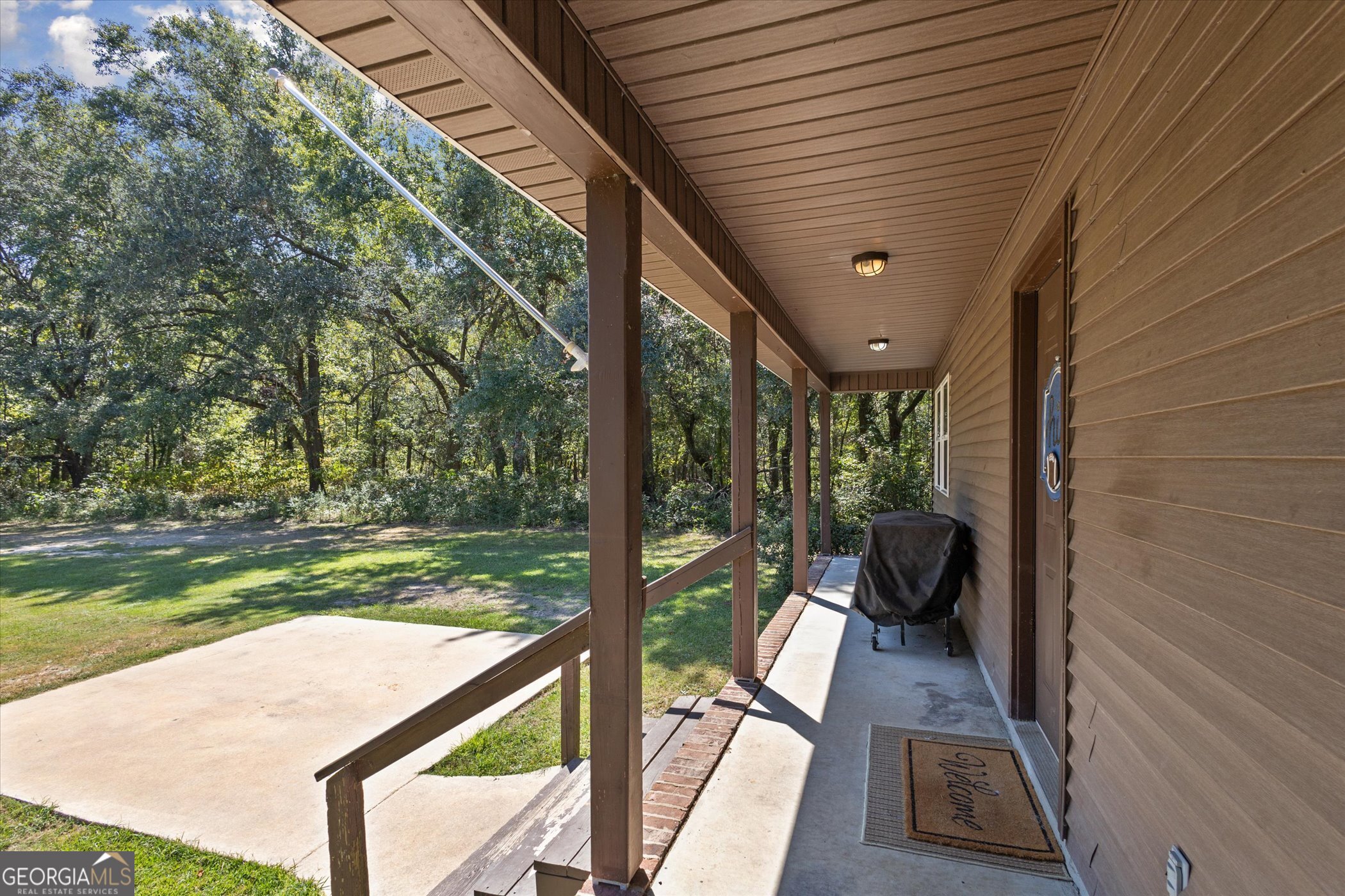 983 Johnny Brannen Road Statesboro, GA 30458 - Photo 3 of 27 a view of a couches and dinning table and chairs in patio