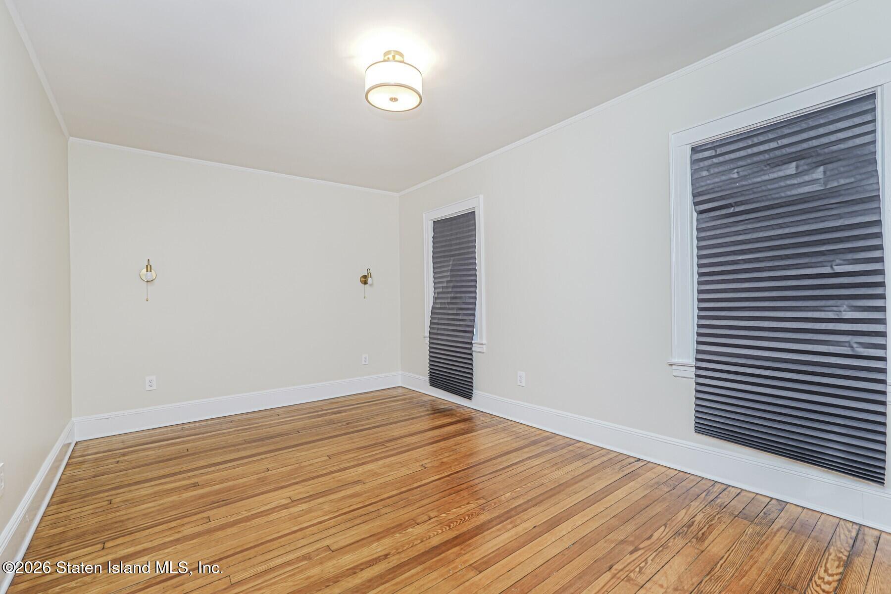 332 Willowbrook Road Staten Island, NY 10314 - Photo 11 of 17 a view of an empty room with wooden floor