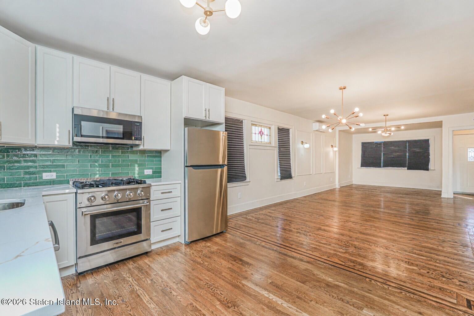 332 Willowbrook Road Staten Island, NY 10314 - Photo 6 of 17 a kitchen with granite countertop a refrigerator stove and oven