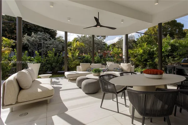a outdoor space with patio couch and a potted plant