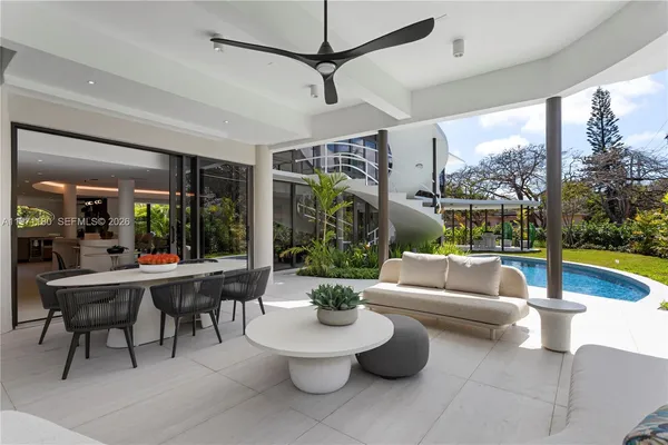 a living room with patio furniture and a tub