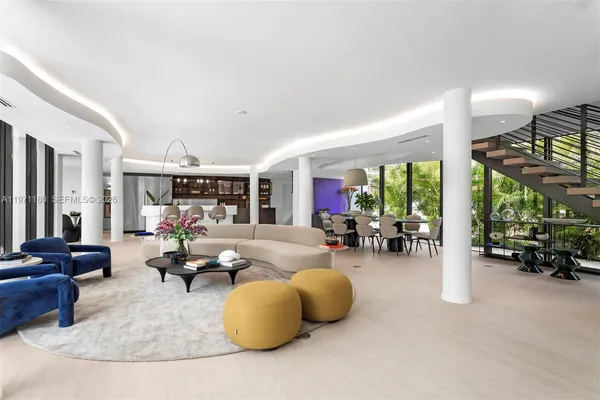 a living room with furniture and a large window with garden view