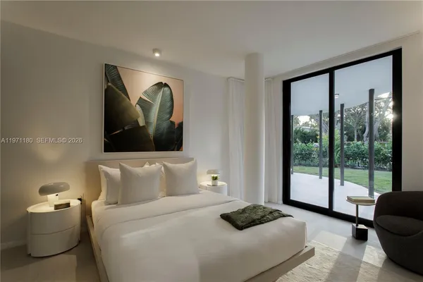 a bedroom with a bed and glass window