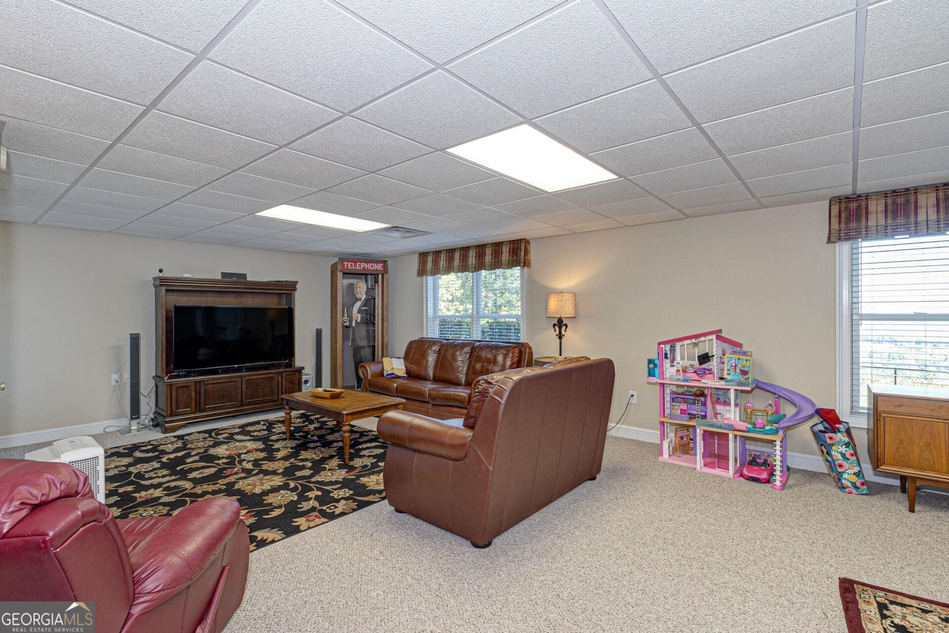 551 Mountain Ridge Drive Manchester, GA 31816 - Photo 39 of 72 The current seller uses this as their basement great room area but the entire basement could be configured many different ways. It would make a great in law suite or teen suite (adding an efficiency kitchen is a possibility)