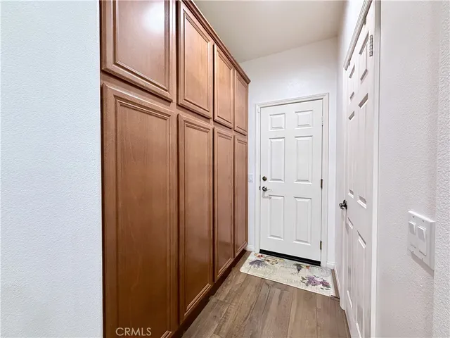 a bathroom with a toilet a sink a mirror and a window