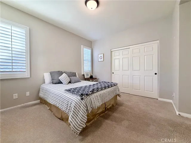 a bathroom with a granite countertop sink a toilet and a glass door shower