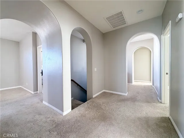 a view of an empty room with a ceiling fan