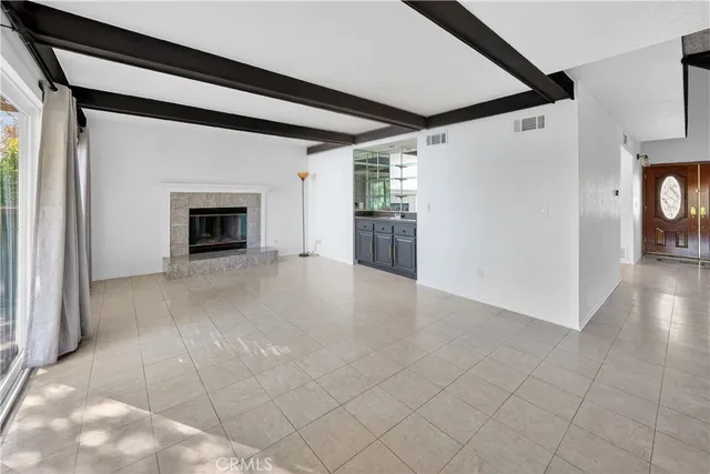 a view of empty room with a fireplace and wooden floor