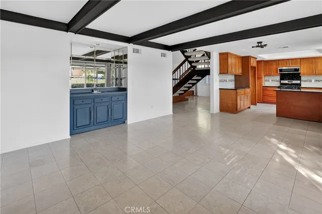 a view of kitchen with furniture and refrigerator